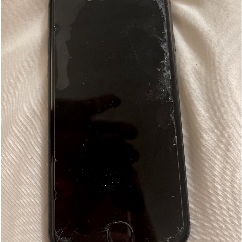 iPhone 8 64GB. Slight cracks around edges of front. Back is cracked.